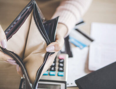 poor Asian woman hand open empty purse looking for money for debt